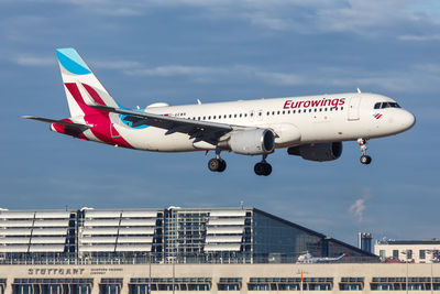 Low angle view of airplane flying against sky