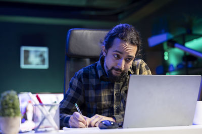 Young man using laptop at home