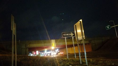 Illuminated bus against sky at night