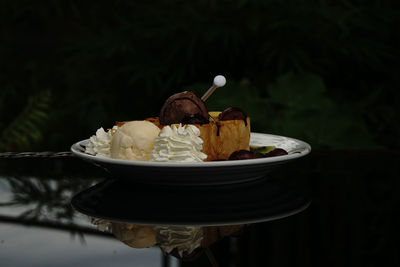 Close-up of ice cream cone on plate