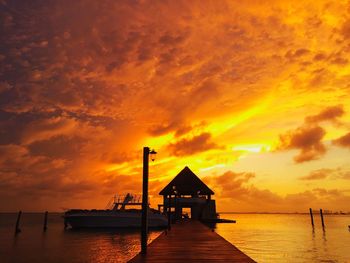 Pier on sea during sunset