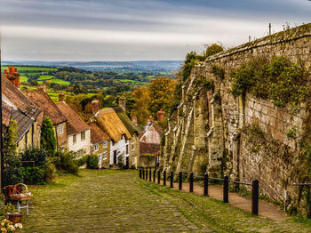 Panoramic shot of houses and trees against sky