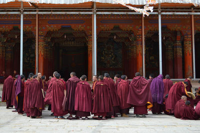 Group of monks standing outside temple