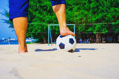 Low section of man playing soccer ball