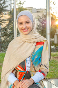 Portrait of smiling beautiful young woman wearing hijab