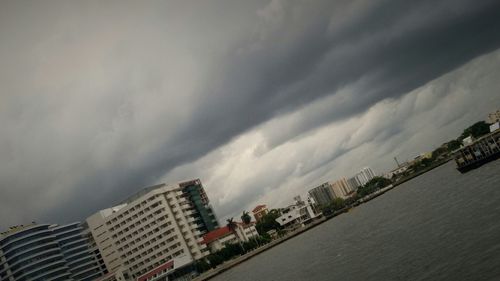 Buildings against cloudy sky