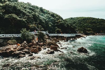 Scenic view of river by trees against sky