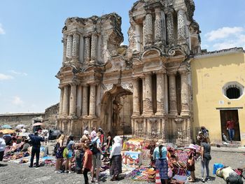 People at temple against sky