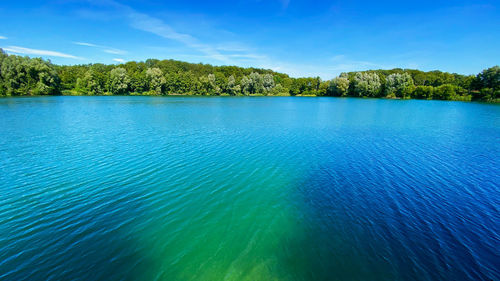 Scenic view of lake against blue sky