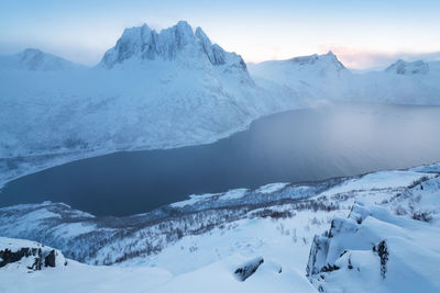 Scenic view of snow covered mountains against sky