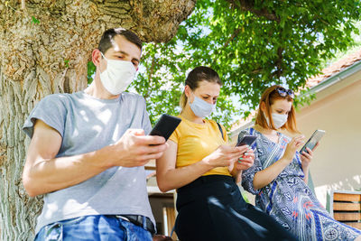 People holding mobile phone at camera