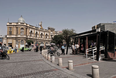 People in city against clear sky