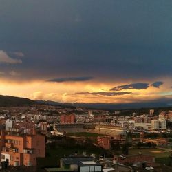 Cityscape against cloudy sky