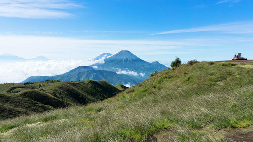 Scenic view of mountains against blue sky