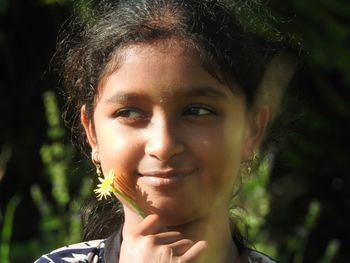 Close-up of smiling girl looking away