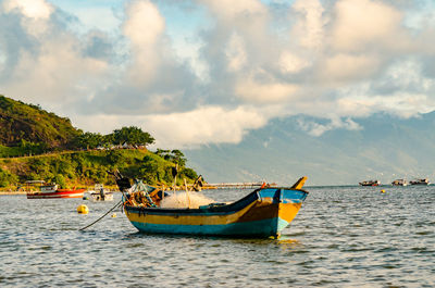 Boat moored in sea against sky