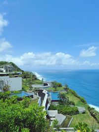 High angle view of townscape by sea against sky