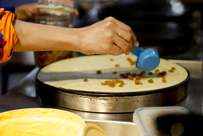 Midsection of person preparing food