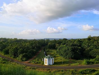 Scenic view of trees and building against sky