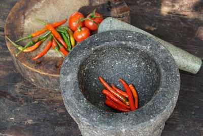 High angle view of red chili peppers on rock