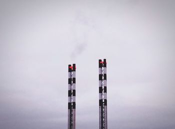 Low angle view of smoke stack against sky