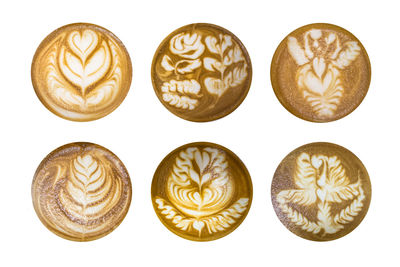 Directly above shot of coffee cups against white background