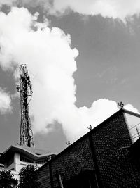 Low angle view of buildings against cloudy sky