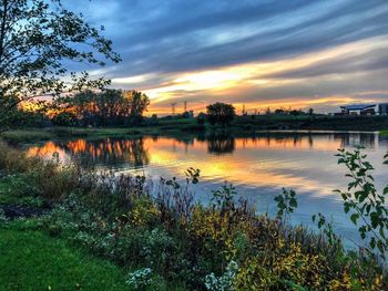 Scenic view of lake against sky at sunset
