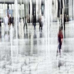 Blurred motion of people walking in city