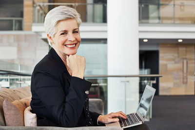 Portrait of smiling young woman using smart phone