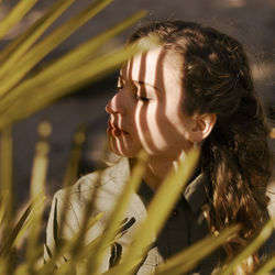 Close-up portrait of young woman looking away