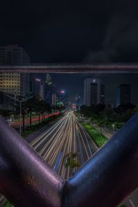 Train in city against sky at night