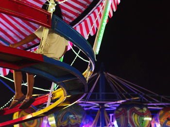 Close-up of amusement park ride at night