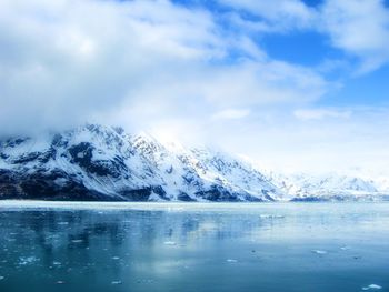 Scenic view of ice covered lake and snow capped mountains 