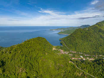 Aerial drone of coast of sumatra with towns and mountains with jungle. indonesia.