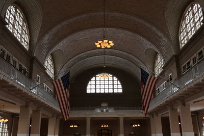 Low angle view of illuminated chandelier hanging in building