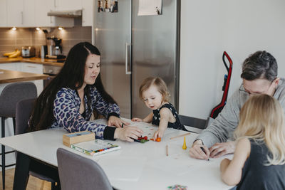 Parents with daughters drawing together
