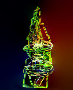 Close-up of illuminated lighting equipment against black background