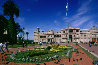 High angle view of people in front of building against sky