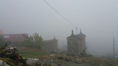 Electricity pylon on mountain against sky