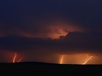 Low angle view of lightning against sky during night