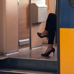 Low section of man with open door