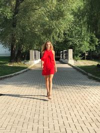 Full length portrait of smiling young woman
