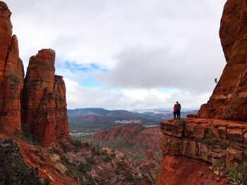 Rear view of woman standing on cliff