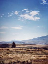 Scenic view of landscape against cloudy sky
