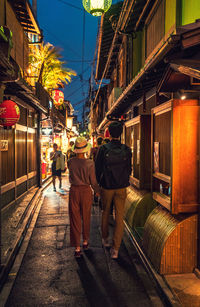 People walking on street at night