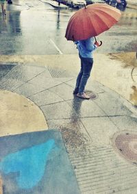 Rear view of woman walking on road