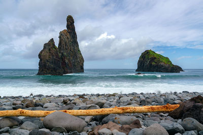 Rocks on beach against sky