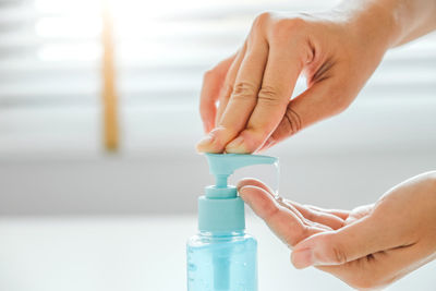 Close-up of hand holding bottle