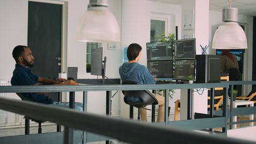 Rear view of man working on table